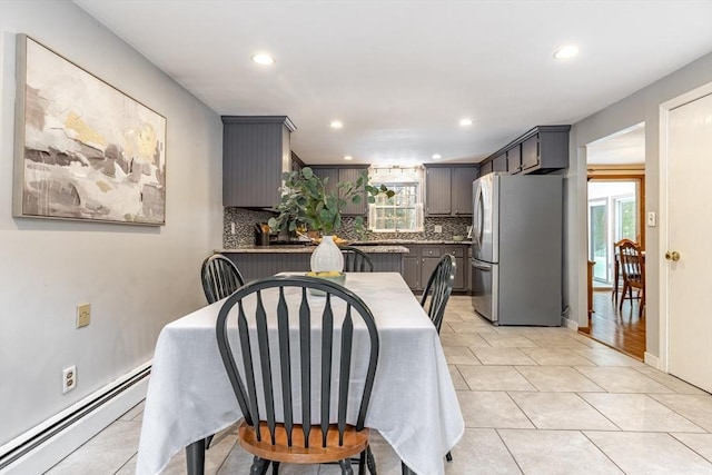 dining space with recessed lighting, baseboards, baseboard heating, and light tile patterned floors