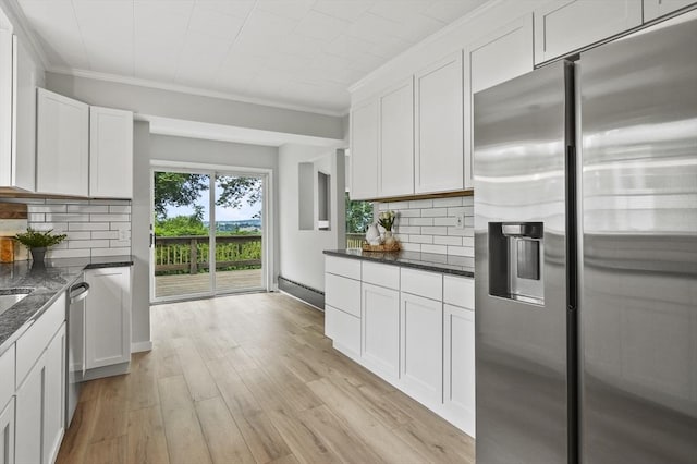 112 Brookline St, Worcester, MA 01603 - kitchen featuring appliances with stainless steel finishes, crown molding, white cabinetry, light wood-style floors, and backsplash