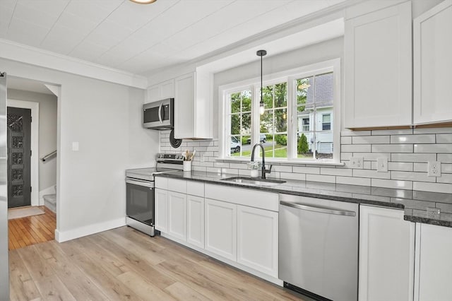 112 Brookline St, Worcester, MA 01603 - kitchen with stainless steel appliances, tasteful backsplash, white cabinetry, dark stone countertops, and crown molding
