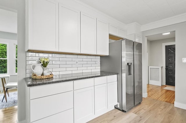 112 Brookline St, Worcester, MA 01603 - kitchen featuring stainless steel fridge, light wood-style flooring, dark stone countertops, white cabinetry, and ornamental molding