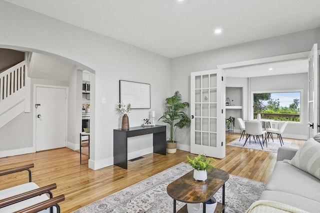 112 Brookline St, Worcester, MA 01603 - living room with arched walkways, light wood-style flooring, stairway, and recessed lighting