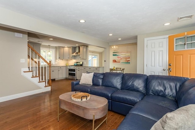 living area with stairs, recessed lighting, baseboards, dark wood-type flooring, and visible vents