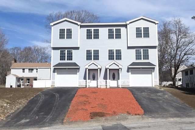 view of front of property with a garage and aphalt driveway
