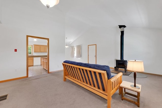 16 Amherst St, Chicopee, MA 01013 - living area featuring light carpet, a wood stove, and lofted ceiling