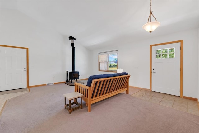 16 Amherst St, Chicopee, MA 01013 - carpeted foyer with plenty of natural light, a wood stove, and tile patterned flooring