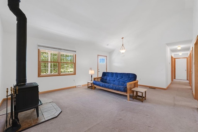 16 Amherst St, Chicopee, MA 01013 - living area featuring a wood stove and carpet