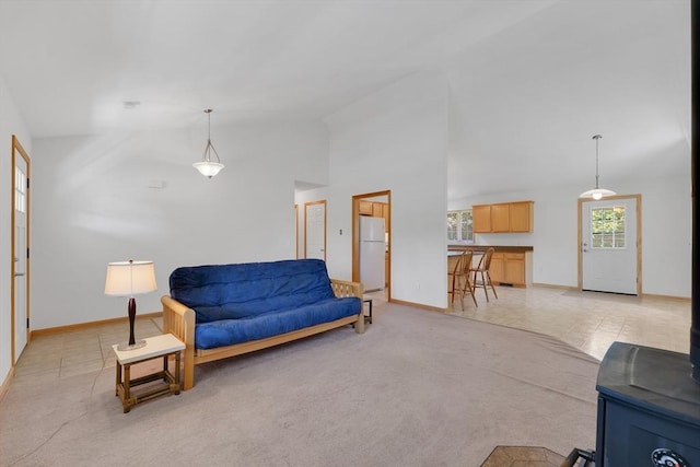 16 Amherst St, Chicopee, MA 01013 - living area with lofted ceiling, light carpet, and a wood stove