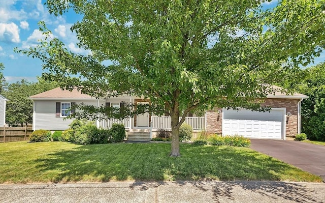 16 Amherst St, Chicopee, MA 01013 - obstructed view of property featuring driveway, a garage, and covered porch