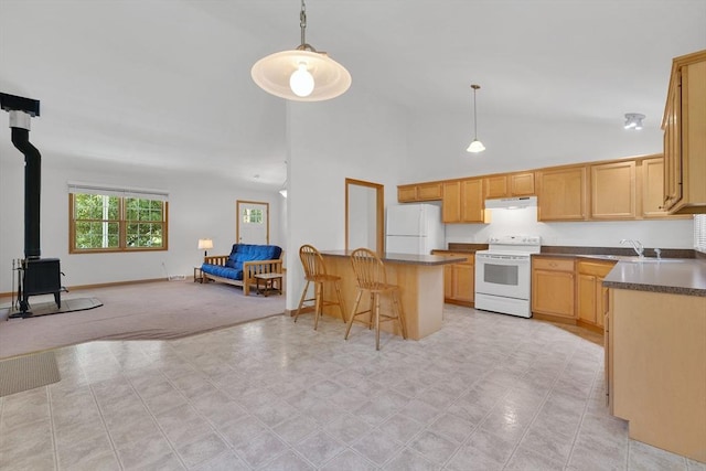 16 Amherst St, Chicopee, MA 01013 - kitchen featuring white appliances, under cabinet range hood, open floor plan, a breakfast bar area, and dark countertops