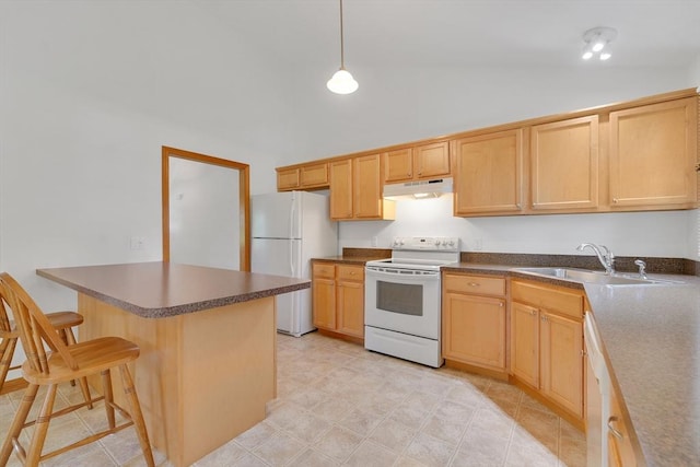 16 Amherst St, Chicopee, MA 01013 - kitchen featuring white appliances, under cabinet range hood, a breakfast bar area, dark countertops, and high vaulted ceiling