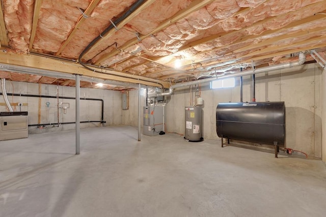 16 Amherst St, Chicopee, MA 01013 - unfinished below grade area with oil tank, electric water heater, washer / dryer, electric panel, and heating unit