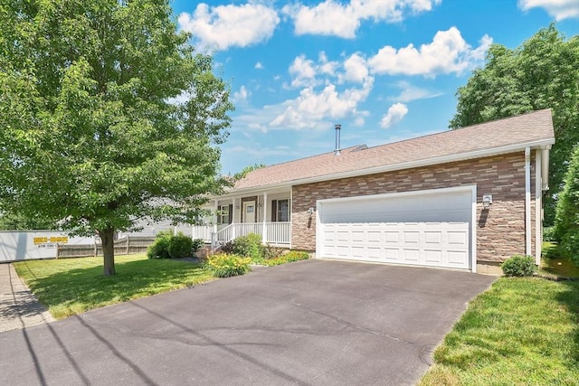 16 Amherst St, Chicopee, MA 01013 - ranch-style house with a porch, driveway, a front yard, a garage, and stone siding