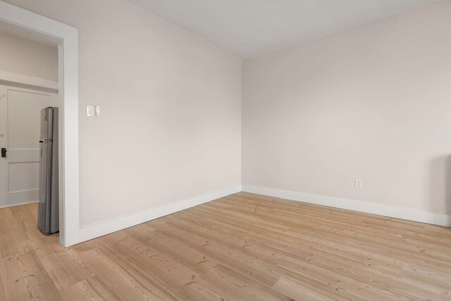 spare room featuring light wood-type flooring