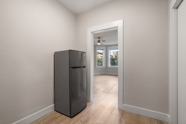 kitchen featuring stainless steel fridge, ceiling fan, and light hardwood / wood-style flooring