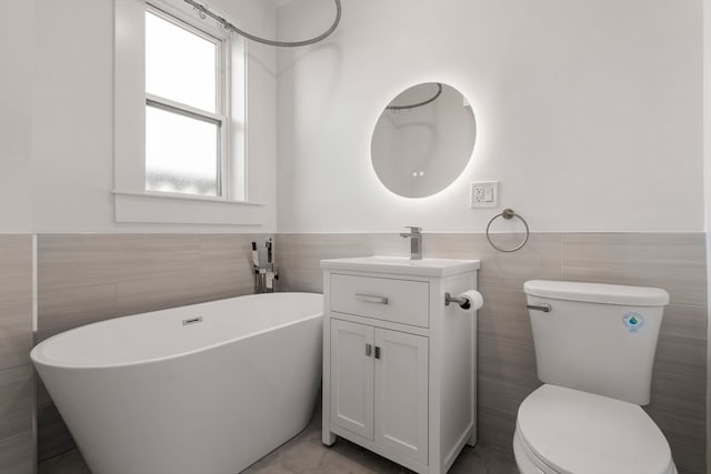 bathroom with tile walls, a washtub, and toilet