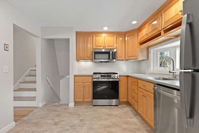 kitchen featuring sink, appliances with stainless steel finishes, and light brown cabinets