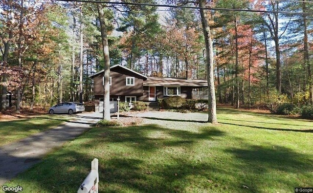 view of front of home with a garage and a front yard