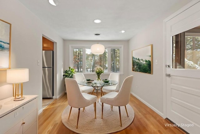 dining area with light hardwood / wood-style flooring