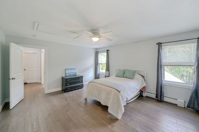 bedroom featuring a baseboard radiator, light wood-type flooring, and ceiling fan