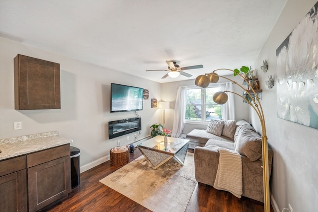 living room featuring dark hardwood / wood-style floors and ceiling fan