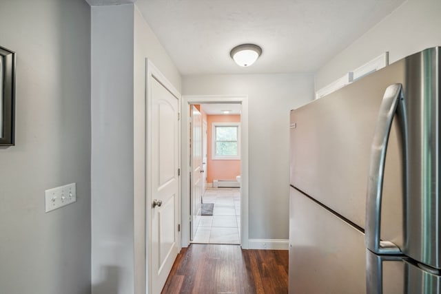 hallway with a baseboard radiator and dark wood-type flooring