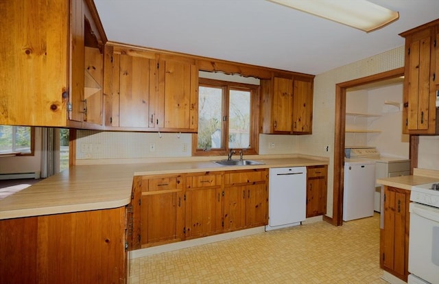 kitchen with brown cabinets, a sink, light countertops, light floors, and white appliances