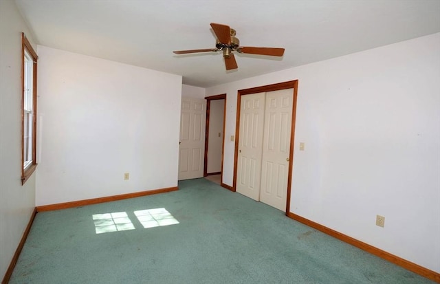 unfurnished bedroom featuring carpet flooring, baseboards, ceiling fan, and a closet