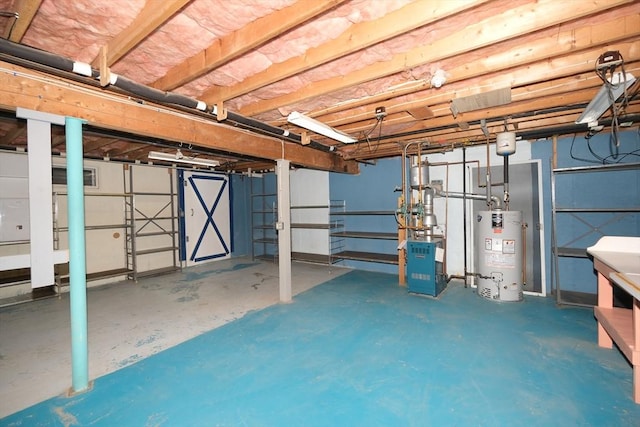 unfinished basement featuring gas water heater and a heating unit