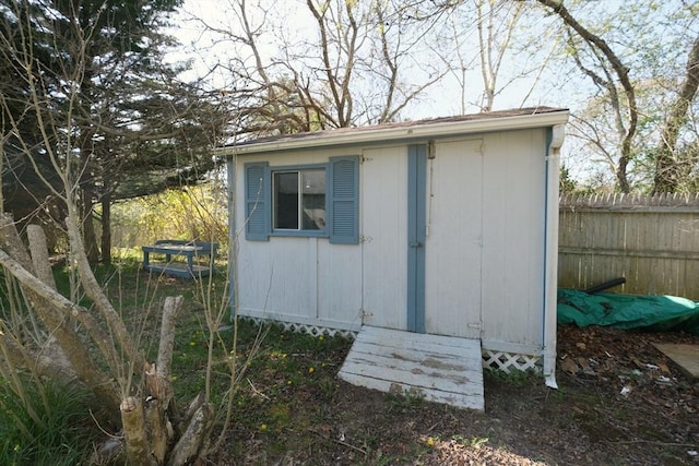 view of shed featuring fence