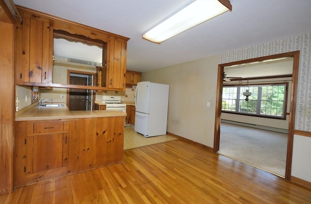 kitchen featuring baseboards, a baseboard radiator, wallpapered walls, and white appliances