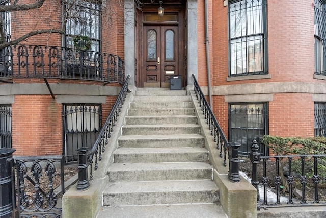 view of exterior entry with brick siding