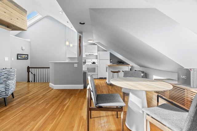 interior space featuring lofted ceiling and light wood finished floors