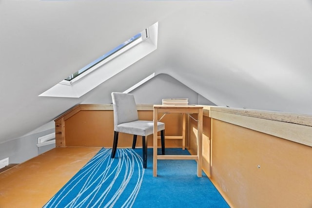 bonus room featuring lofted ceiling with skylight and carpet flooring