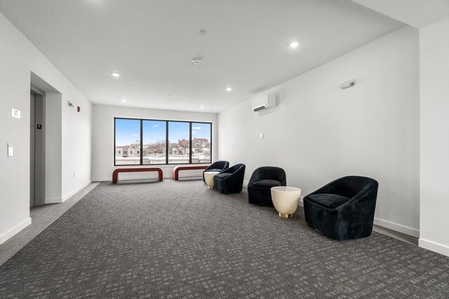 unfurnished room with baseboards, a wall unit AC, carpet flooring, and recessed lighting