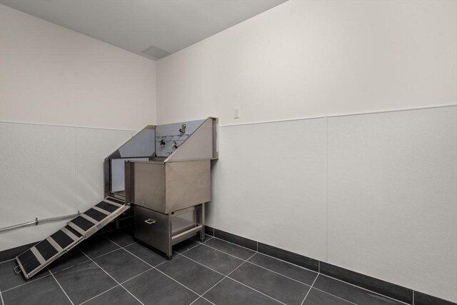 miscellaneous room featuring dark tile patterned flooring