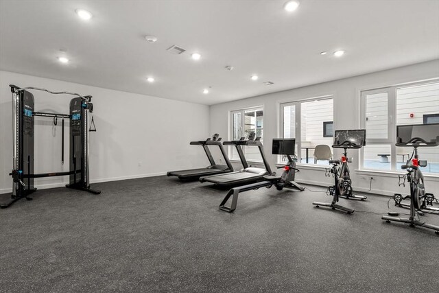 exercise room featuring baseboards, recessed lighting, and visible vents