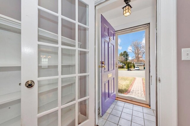 entryway with light tile patterned floors