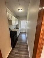 kitchen featuring white cabinets and dark hardwood / wood-style flooring