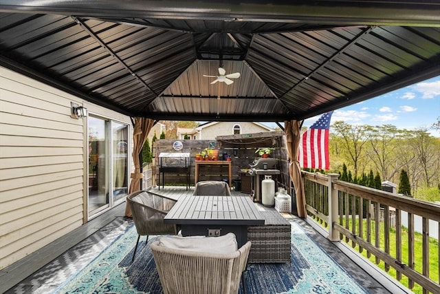 wooden terrace with a gazebo and outdoor dining space