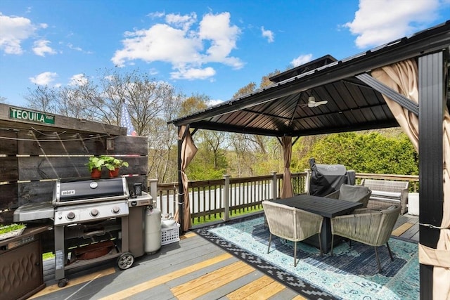 deck featuring a gazebo and outdoor dining area