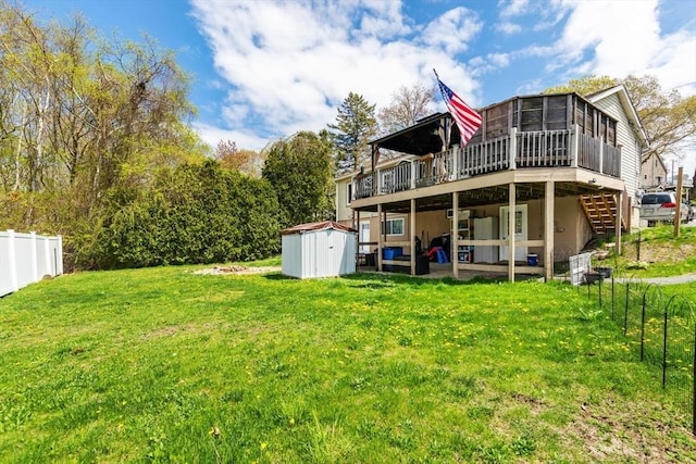 rear view of property with stairs, a deck, a shed, an outbuilding, and a sunroom