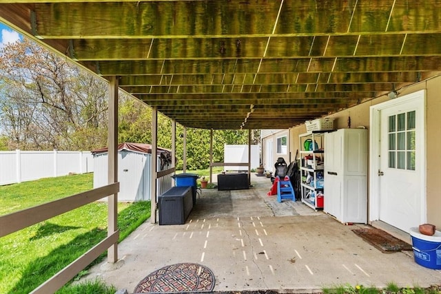 view of patio with a storage unit and an outdoor structure