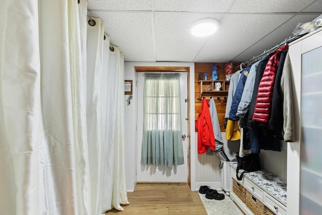 mudroom featuring wood finished floors, a paneled ceiling, and baseboards