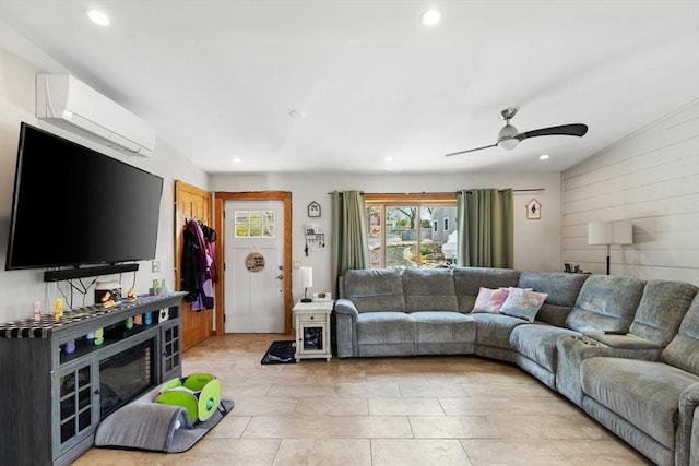 living area featuring a wall mounted AC, recessed lighting, a ceiling fan, and wooden walls