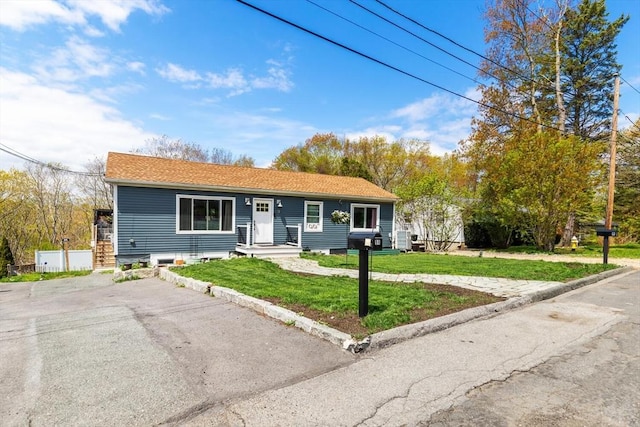 ranch-style home with a front lawn