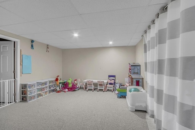 rec room with a paneled ceiling and carpet floors