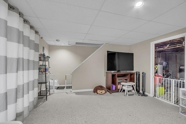 basement with a paneled ceiling and carpet floors