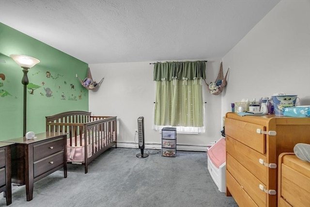 bedroom featuring baseboard heating, a nursery area, dark carpet, and a textured ceiling