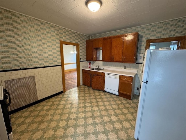 915 E 4th St, Boston, MA 02127 - kitchen with white appliances, tile patterned floors, a sink, wallpapered walls, and light countertops