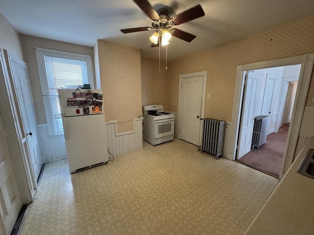 915 E 4th St, Boston, MA 02127 - clothes washing area featuring radiator, wallpapered walls, ceiling fan, light floors, and a wainscoted wall
